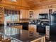 Kitchen featuring black appliances and bar seating at 451 Harris Dr, Idaho Springs, CO 80452