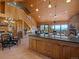 Inviting living room with vaulted wood ceilings, fireplace, and open floor plan with mountain views at 451 Harris Dr, Idaho Springs, CO 80452