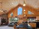 Open-concept living room with wood vaulted ceilings and scenic view at 451 Harris Dr, Idaho Springs, CO 80452