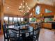 Expansive living space with wooden interior, dining table, and great views from large glass doors at 451 Harris Dr, Idaho Springs, CO 80452