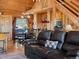 Warm wooden interior with a comfortable leather sofa and rustic decor create a cozy living space at 451 Harris Dr, Idaho Springs, CO 80452