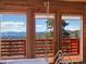 Stunning mountain views through wood-framed windows with access to a balcony at 451 Harris Dr, Idaho Springs, CO 80452