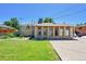 Brick home with a green lawn and a concrete patio in a fenced backyard at 505 Empire St, Aurora, CO 80010