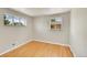Bright bedroom with hardwood floors and two windows offering ample natural light at 505 Empire St, Aurora, CO 80010
