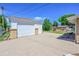 Detached garage with a driveway and additional shed in the backyard at 505 Empire St, Aurora, CO 80010