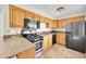 Traditional kitchen featuring wood cabinets, granite countertops, and stainless steel appliances at 505 Empire St, Aurora, CO 80010