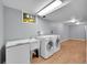 Finished basement laundry room with linoleum flooring, utility sink and washer/dryer hookups at 505 Empire St, Aurora, CO 80010