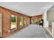 Spacious living room with wood-paneled walls, large windows, plush carpeting, and a cozy fireplace at 505 Empire St, Aurora, CO 80010