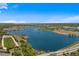A scenic aerial view of a serene lake surrounded by lush greenery, offering a tranquil and picturesque setting at 7050 S Polo Ridge Dr, Littleton, CO 80128