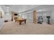 Finished basement features a pool table, stone fireplace, and ample recreational space at 7050 S Polo Ridge Dr, Littleton, CO 80128