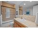 Bathroom with a tub, tiled shower with glass door, and a decorative tiled backsplash at 7050 S Polo Ridge Dr, Littleton, CO 80128