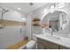 Stylishly updated bathroom featuring decorative tile accents, glass enclosed shower, and modern vanity at 7050 S Polo Ridge Dr, Littleton, CO 80128
