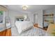 Comfortable bedroom features a reading nook with built-in shelving and hardwood floors at 7050 S Polo Ridge Dr, Littleton, CO 80128