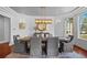 Formal dining room with an elegant chandelier, large window, and designer touches at 7050 S Polo Ridge Dr, Littleton, CO 80128