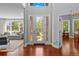 Bright entryway features a decorative glass front door and views into the living spaces at 7050 S Polo Ridge Dr, Littleton, CO 80128