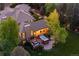 Aerial view showcasing the back of the property with its spa, covered deck, and lush greenery at 7050 S Polo Ridge Dr, Littleton, CO 80128