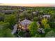 Stunning home featuring a lush landscaped yard, driveway, and outdoor spa at 7050 S Polo Ridge Dr, Littleton, CO 80128