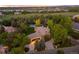 Aerial view of home with lush landscaping, long driveway, and lake views at 7050 S Polo Ridge Dr, Littleton, CO 80128