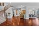 Elegant foyer featuring hardwood floors, a curved staircase, and stylish decor at 7050 S Polo Ridge Dr, Littleton, CO 80128