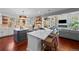 Bright kitchen with a large island, marble countertops, stainless steel appliances, and an open floor plan at 7050 S Polo Ridge Dr, Littleton, CO 80128