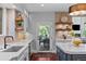 A spacious kitchen with stainless steel appliances, plenty of cabinet space, and access to a beautiful outdoor patio at 7050 S Polo Ridge Dr, Littleton, CO 80128