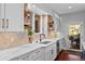 Bright kitchen featuring an island, stainless steel appliances, ample counter space, and access to the outdoor patio at 7050 S Polo Ridge Dr, Littleton, CO 80128