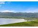 Scenic view of a serene lake and distant mountains, perfect for enjoying nature's beauty at 7050 S Polo Ridge Dr, Littleton, CO 80128
