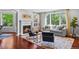 Cozy living room featuring large windows, a fireplace, and contemporary furniture at 7050 S Polo Ridge Dr, Littleton, CO 80128