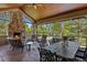 Inviting outdoor patio features a stone fireplace, comfortable seating, ceiling fan, and an elegant wrought iron table set at 7050 S Polo Ridge Dr, Littleton, CO 80128
