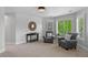 Bright sitting room with comfortable seating, neutral paint, and natural light from the window at 7050 S Polo Ridge Dr, Littleton, CO 80128