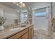 This bright bathroom features dual sinks, tile backsplash, and a tub/shower combo with marble curtain at 145 Kettle Valley Way, Monument, CO 80132