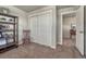 Bedroom featuring a decorative shelf unit with a chair and a closet with white sliding doors at 145 Kettle Valley Way, Monument, CO 80132