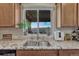 Kitchen sink under a window with a beautiful mountain view and granite countertops at 145 Kettle Valley Way, Monument, CO 80132