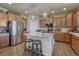 Bright kitchen with a granite countertop island, modern appliances, and wooden cabinets at 145 Kettle Valley Way, Monument, CO 80132