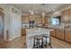 Well-lit kitchen features a granite countertop island, wooden cabinets, and stainless steel appliances at 145 Kettle Valley Way, Monument, CO 80132