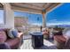 Relaxing covered patio with comfortable seating and mountain views at 145 Kettle Valley Way, Monument, CO 80132
