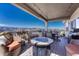 Spacious covered patio features fire pit, dining area, and mountain views at 145 Kettle Valley Way, Monument, CO 80132
