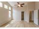 Light-filled bedroom with vaulted ceiling, fan, and large windows at 5137 Mt Arapaho Cir, Frederick, CO 80504