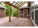 Inviting deck featuring a wood pergola and string lights, ideal for outdoor relaxation and entertaining with a red door at 5137 Mt Arapaho Cir, Frederick, CO 80504