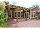 Spacious outdoor deck with pergola and glass door for seamless indoor/outdoor living with lush landscaping at 5137 Mt Arapaho Cir, Frederick, CO 80504