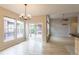 Bright dining area featuring a modern chandelier and sliding glass doors to the deck at 5137 Mt Arapaho Cir, Frederick, CO 80504