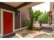 Charming entryway with a vibrant red door, stone pathway, and lush landscaping, creating a welcoming first impression at 5137 Mt Arapaho Cir, Frederick, CO 80504