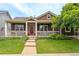Charming home featuring a covered porch with a red front door and well-maintained landscaping at 5137 Mt Arapaho Cir, Frederick, CO 80504