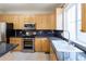 Bright kitchen featuring stainless steel appliances and granite countertops at 5137 Mt Arapaho Cir, Frederick, CO 80504