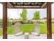 Inviting backyard featuring swing chairs under a pergola, offering a serene outdoor retreat at 11880 W 38Th Pl, Wheat Ridge, CO 80033