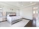 Bright bedroom with white walls and decorative headboard, large windows with view to bathroom with soaking tub at 11880 W 38Th Pl, Wheat Ridge, CO 80033