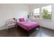Cozy bedroom with hardwood floors, natural light, and a comfortable bed; perfect for relaxation at 11880 W 38Th Pl, Wheat Ridge, CO 80033