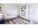 Cozy bedroom with a patterned rug, book shelving, and a closet for storage at 11880 W 38Th Pl, Wheat Ridge, CO 80033