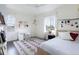 Bright bedroom with a large window, stylish rug, desk, and cozy bed setup at 11880 W 38Th Pl, Wheat Ridge, CO 80033