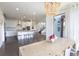 Bright dining room with natural wood table, bench seating, modern lighting, and sliding glass doors to the backyard at 11880 W 38Th Pl, Wheat Ridge, CO 80033